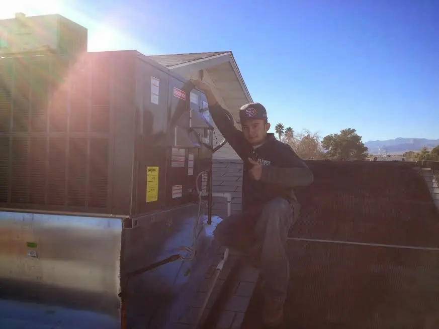 HVAC technician performing Boiler Repair on a rooftop unit in Cayce